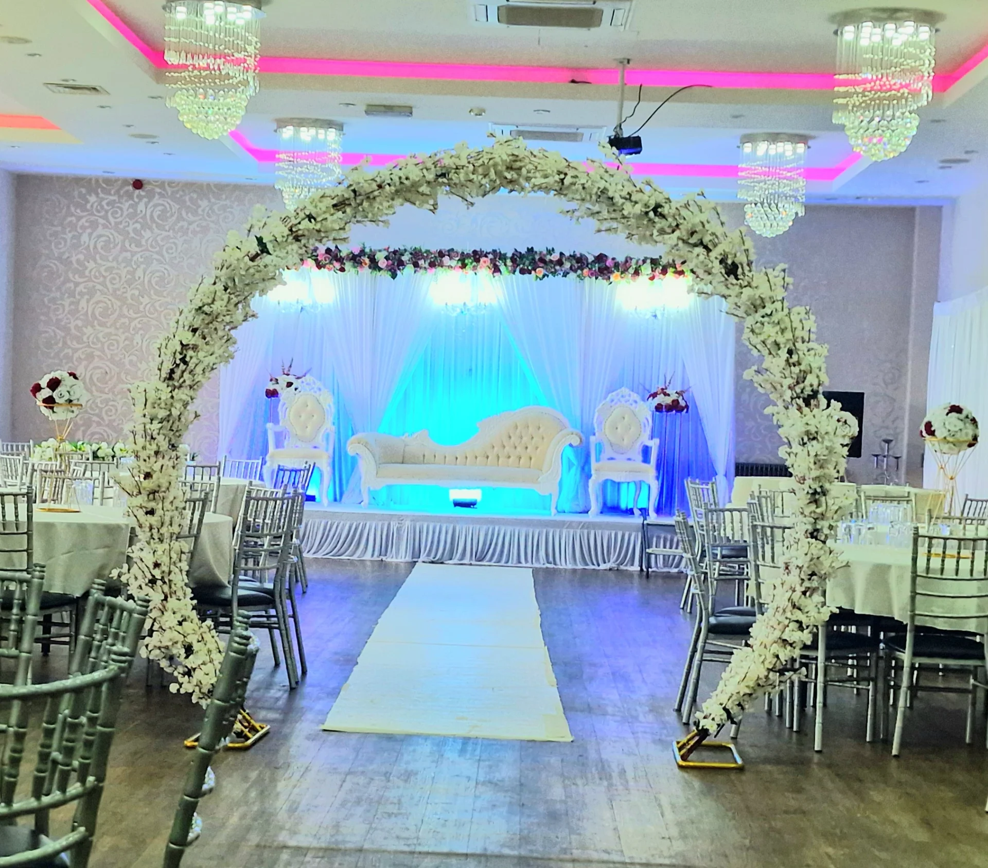 Floral arch framing the wedding stage